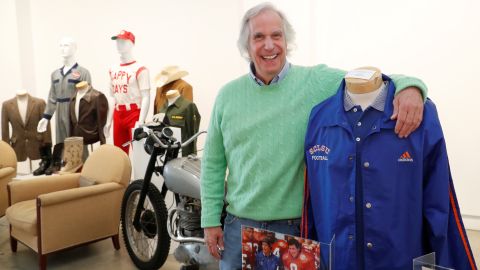 Actor Henry Winkler poses with items from his collection that are going up for auction in Los Angeles.