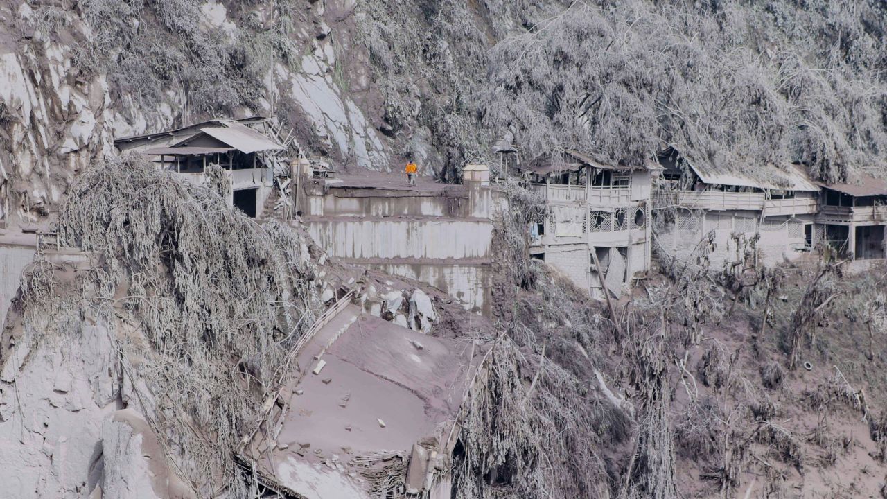 Ash covers houses and trees on the slopes of Mount Semeru in Lumajang on December 5.