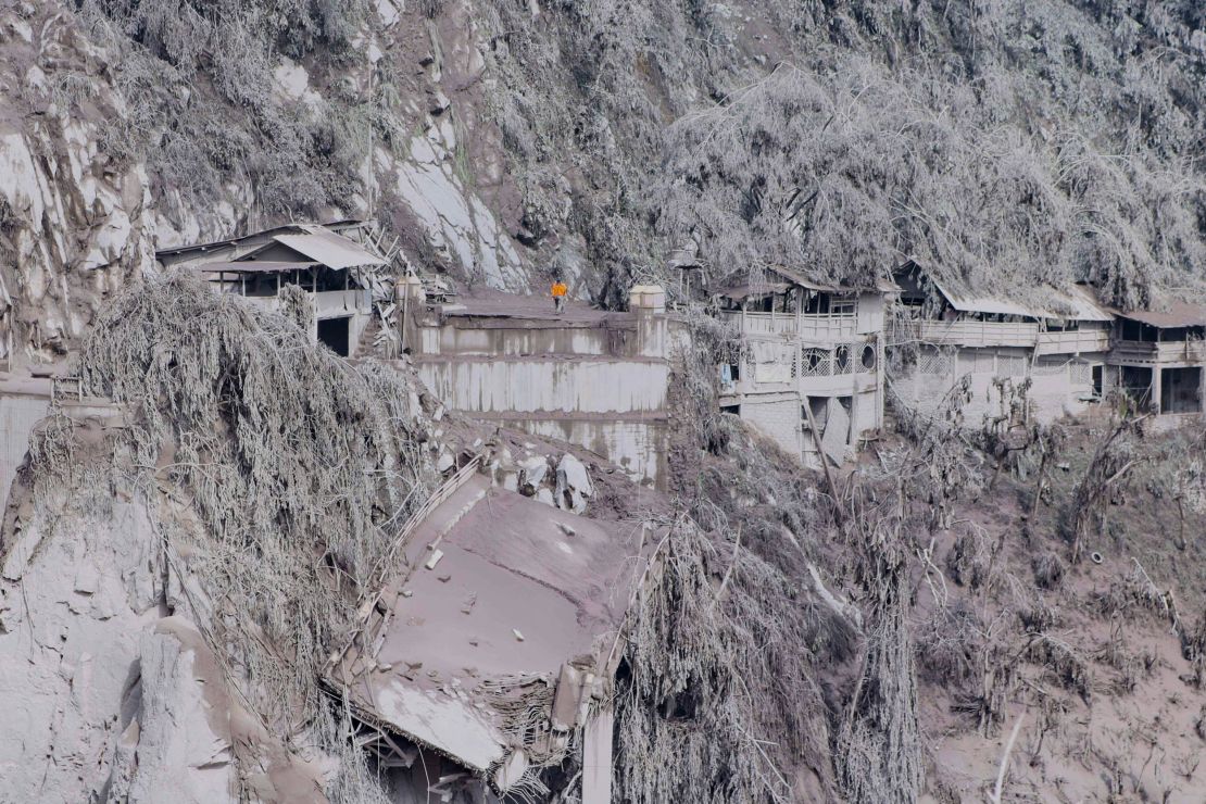 Ash covers houses and trees on the slopes of Mount Semeru in Lumajang on December 5.