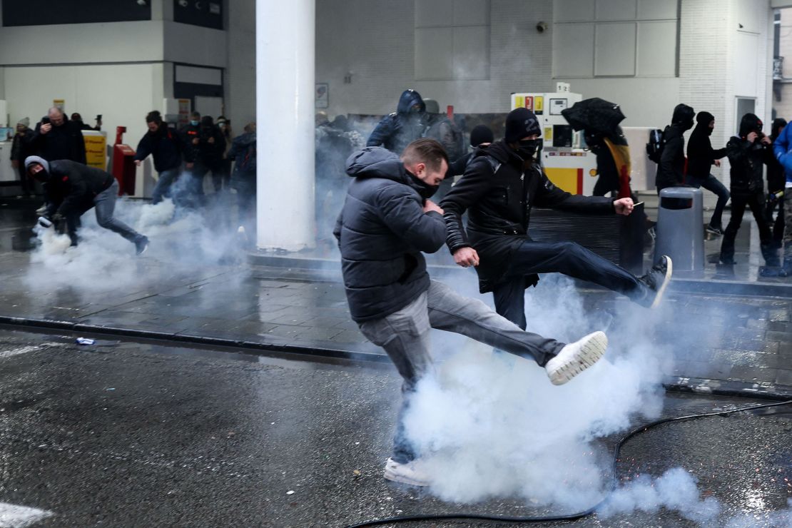 Protesters confront riot police during a demonstration against Covid-19 measures in Brussels, on december 5, 2021. 