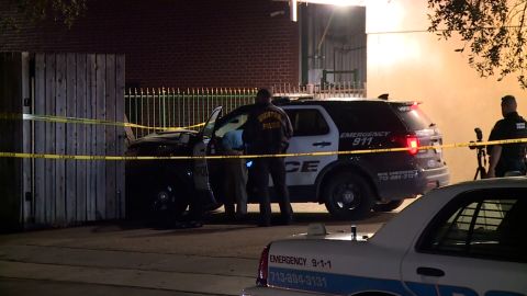 Authorities investigate the scene after a Houston police cruiser lost control and killed a pedestrian.