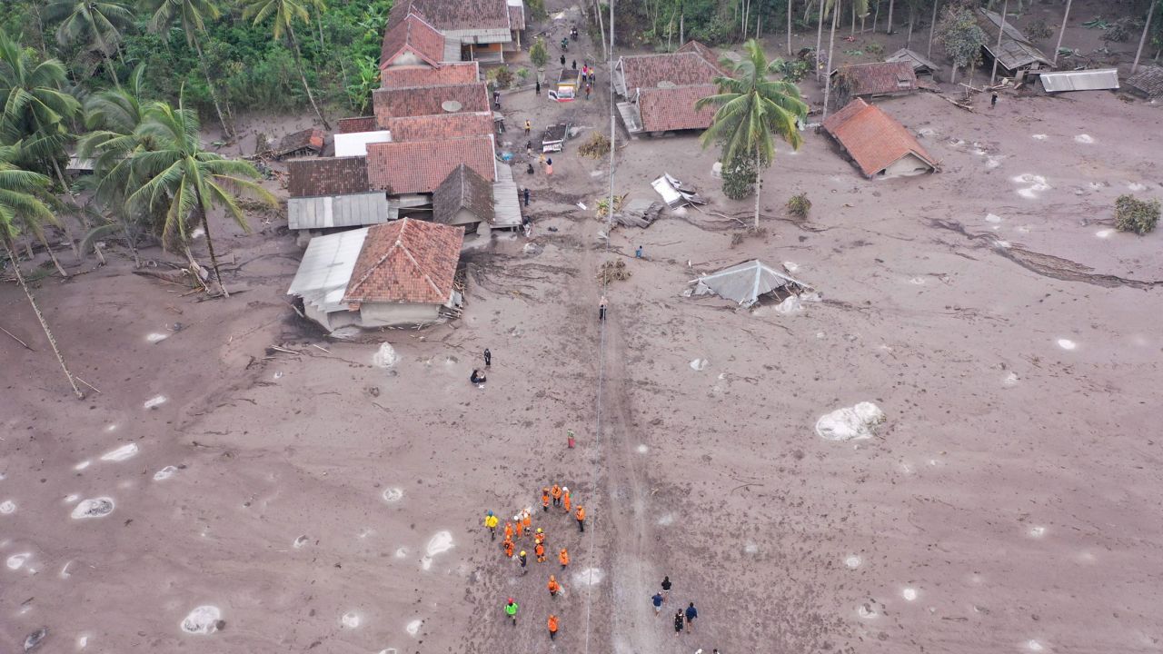 Members of a search and rescue team conduct a search operation for missing people at the Sumberwuluh village on December 6, 2021.
