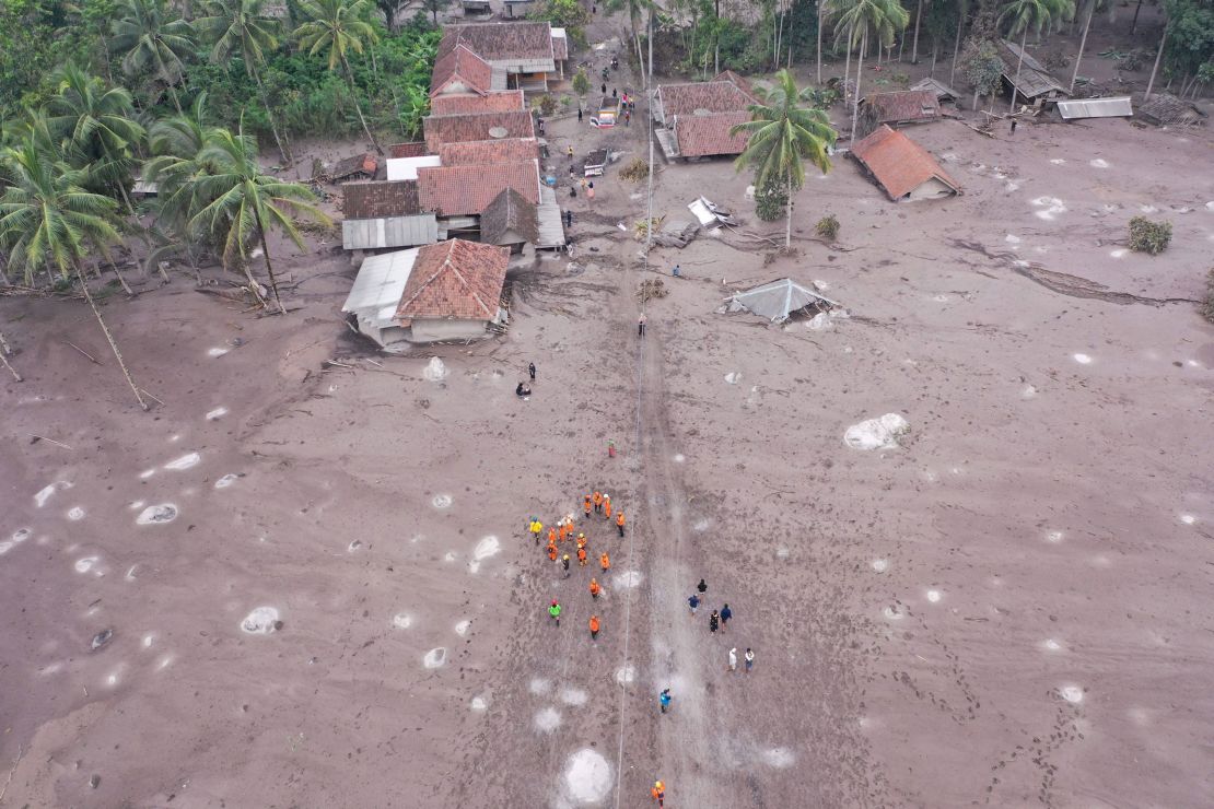 Members of a search and rescue team conduct a search operation for missing people at the Sumberwuluh village on December 6, 2021. 