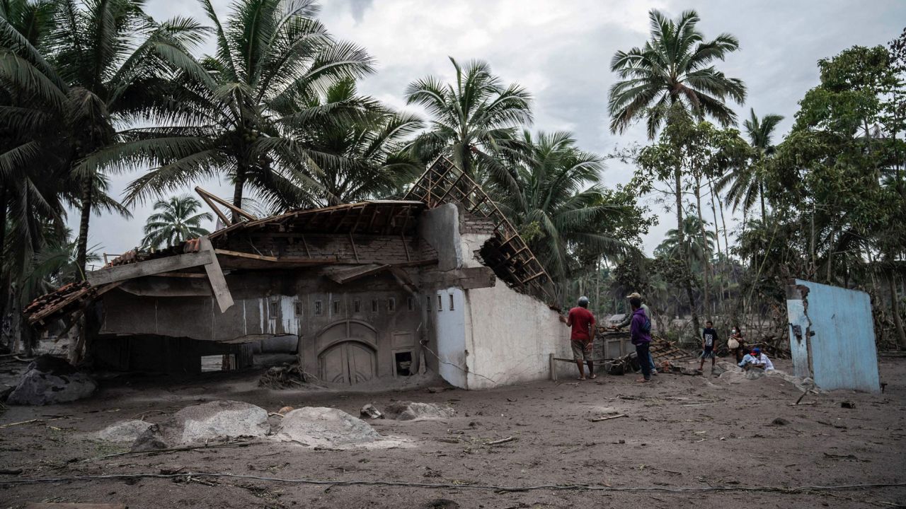 Villagers salvage what they can from their damaged homes at Sumber Wuluh village in Lumajang on December 6, 2021.