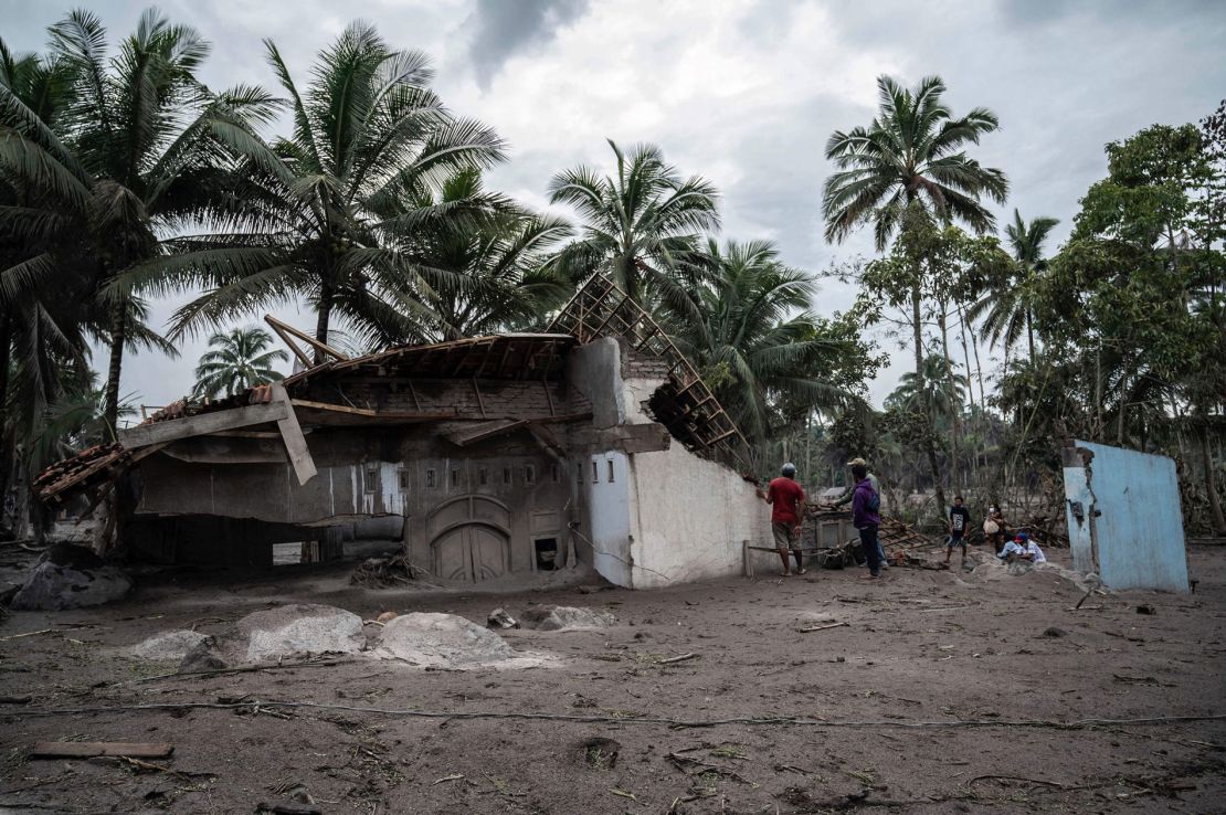 Villagers salvage what they can from their damaged homes at Sumber Wuluh village in Lumajang on December 6, 2021.