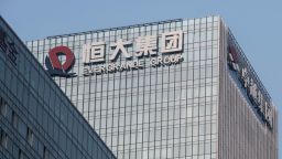The China Evergrande Group logo displayed atop the company's headquarters in Shenzhen, China, on Thursday, Sept. 30, 2021. China Evergrande Group started returning a small portion of the money owed to buyers of its investment products, weeks after people protested against missed payments. Photographer: Gilles Sabrie/Bloomberg via Getty Images