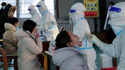 TOPSHOT - This photo taken on December 1, 2021 shows residents undergoing nucleic acid tests for the Covid-19 coronavirus in Hulun Buir, in China's Inner Mongolia Region. - China OUT (Photo by AFP) / China OUT (Photo by STR/AFP via Getty Images)