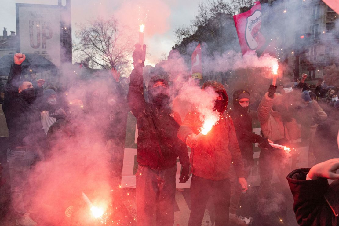 Protesters light flares as leftwing political groups gather to protest Sunday against Zemmour's entrance into the French presidential election.