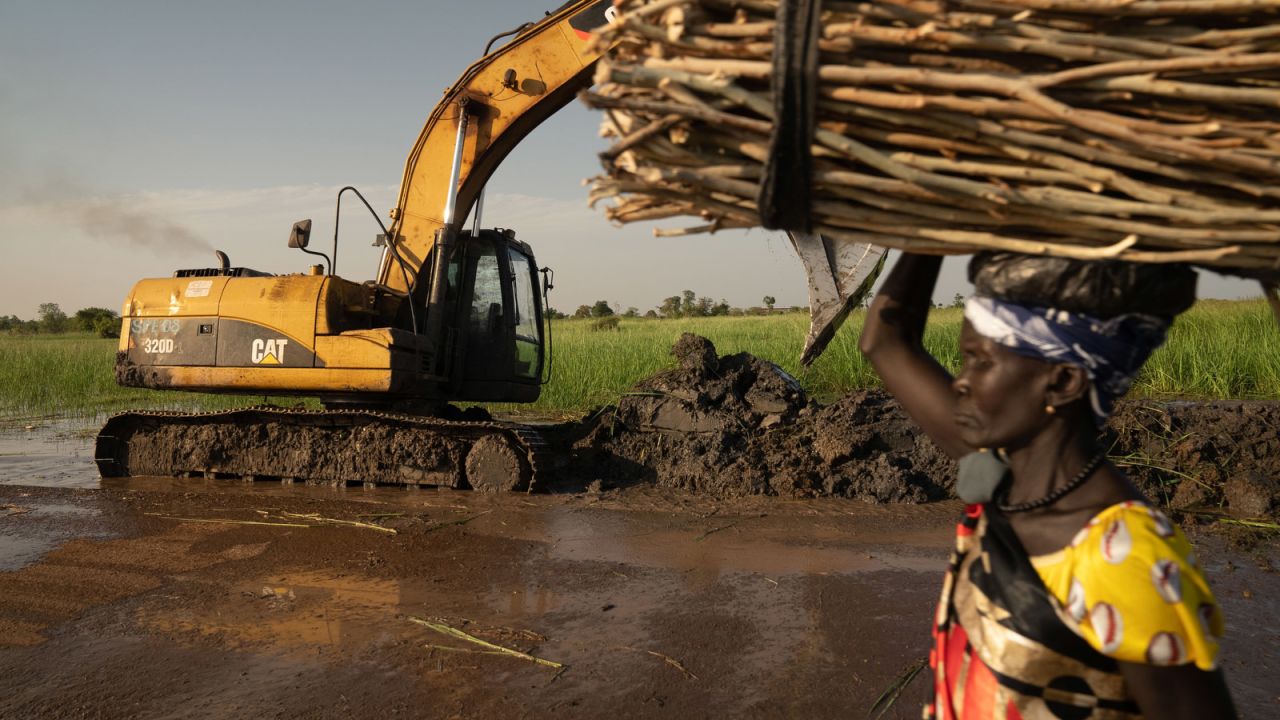 A UN mission repairs a damaged dike.