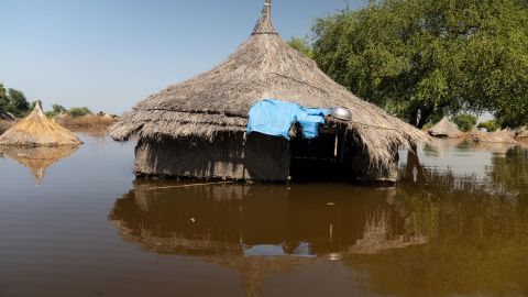 A hut with a straw roof pokes out from the floodwaters in the town of Ding Ding. 