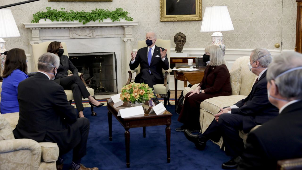 U.S. President Joe Biden, center, wears a protective mask while speaking during a meeting with a group of bipartisan lawmakers in the Oval Office of White House in Washington, D.C., U.S., on Wednesday, March 3, 2021. Biden has agreed to moderate Democrats' demands to narrow eligibility for stimulus checks, but rejected a push to trim extra unemployment benefits, as he tries to win support for his $1.9 trillion pandemic-relief bill, according to a Democratic aide. Photographer: Yuri Gripas/Abaca/Bloomberg via Getty Images