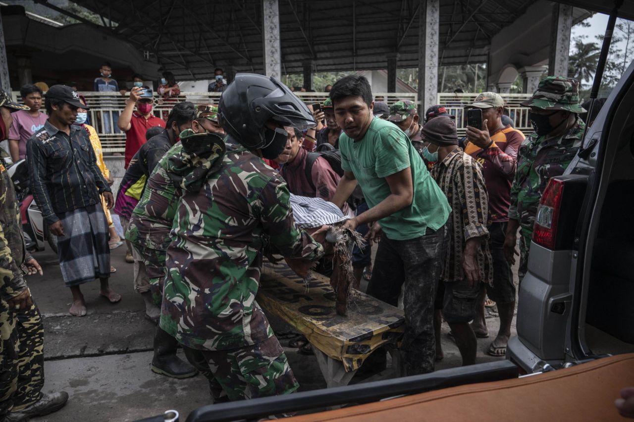 Rescue workers transport a victim in Sumberwuluh on Sunday.