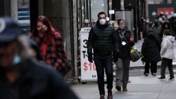 People wear face masks in Manhattan on November 29, 2021 in New York City. Across New York City and the nation, people are being encouraged to get either the booster shot or the Covid-19 vaccine, especially with the newly discovered omicron variant slowly emerging in countries around the world. While there are no cases yet discovered in America, New York's governor Kathy Hochul has declared a state of emergency ahead of the risk of COVID-19 spikes as winter sets in. 