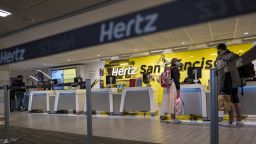 Customers at the Hertz rental counter at San Francisco International Airport in San Francisco, California, U.S., on Wednesday, Oct. 27, 2021. 