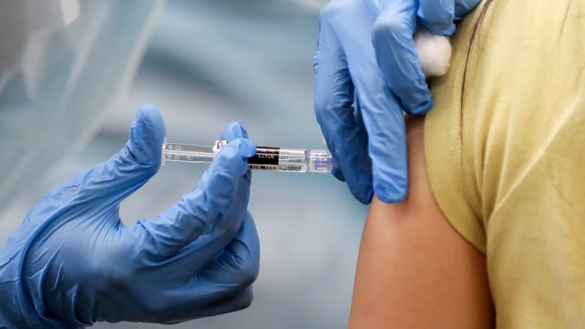 A nurse administers a flu vaccination shot to a woman at a free clinic held at a local library on October 14, 2020 in Lakewood, California. Medical experts are hoping the flu shot this year will help prevent a 'twindemic'- an epidemic of influenza paired with a second wave of COVID-19 which could lead to overwhelmed hospitals amid the coronavirus pandemic. (