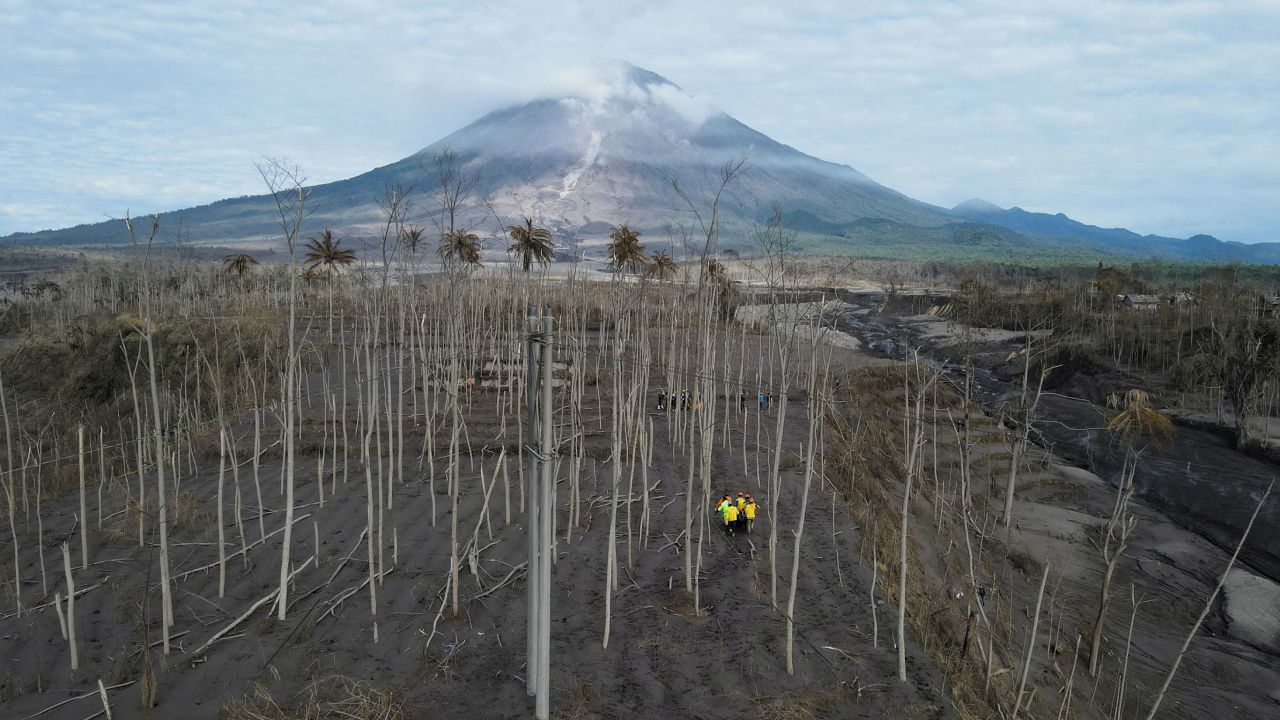 Rescue volunteers carry a body bag at an area affected by the eruption of Mount Semeru volcano in Lumajang, Indonesia, on December 7.