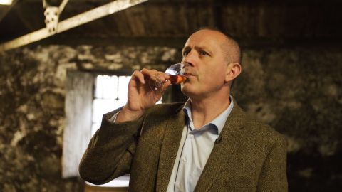 Edward Thom, the Glenmorangie Distillery manager, taking a sip of whiskey straight from the cask. 