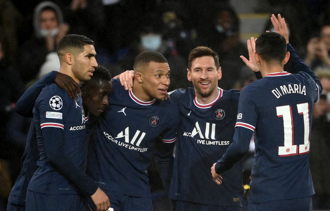 Lionel Messi and Mbappe celebrate with teammates. 