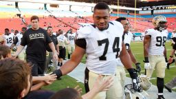 New Orleans Saints defensive end Glenn Foster (74) greets fans after practice before an NFL preseason football game against the Miami Dolphins, Thursday, Aug. 29, 2013 in Miami Gardens, Fla. (AP Photo/Wilfredo Lee)