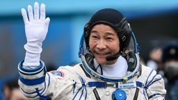 TOPSHOT - Japanese billionaire Yusaku Maezawa waves before boarding the Soyuz MS-20 spacecraft prior to the launch at the Baikonur cosmodrome on December 8, 2021. - Japanese billionaire Yusaku Maezawa and his assistant Yozo Hirano, led by Roscosmos cosmonaut Alexander Misurkin, will blast off to the International Space Station (ISS) onboard the Soyuz MS-20 spacecraft from the Russia-leased Baikonur cosmodrome in Kazakhstan at 0738 GMT. (Photo by Kirill KUDRYAVTSEV / POOL / AFP) (Photo by KIRILL KUDRYAVTSEV/POOL/AFP via Getty Images)