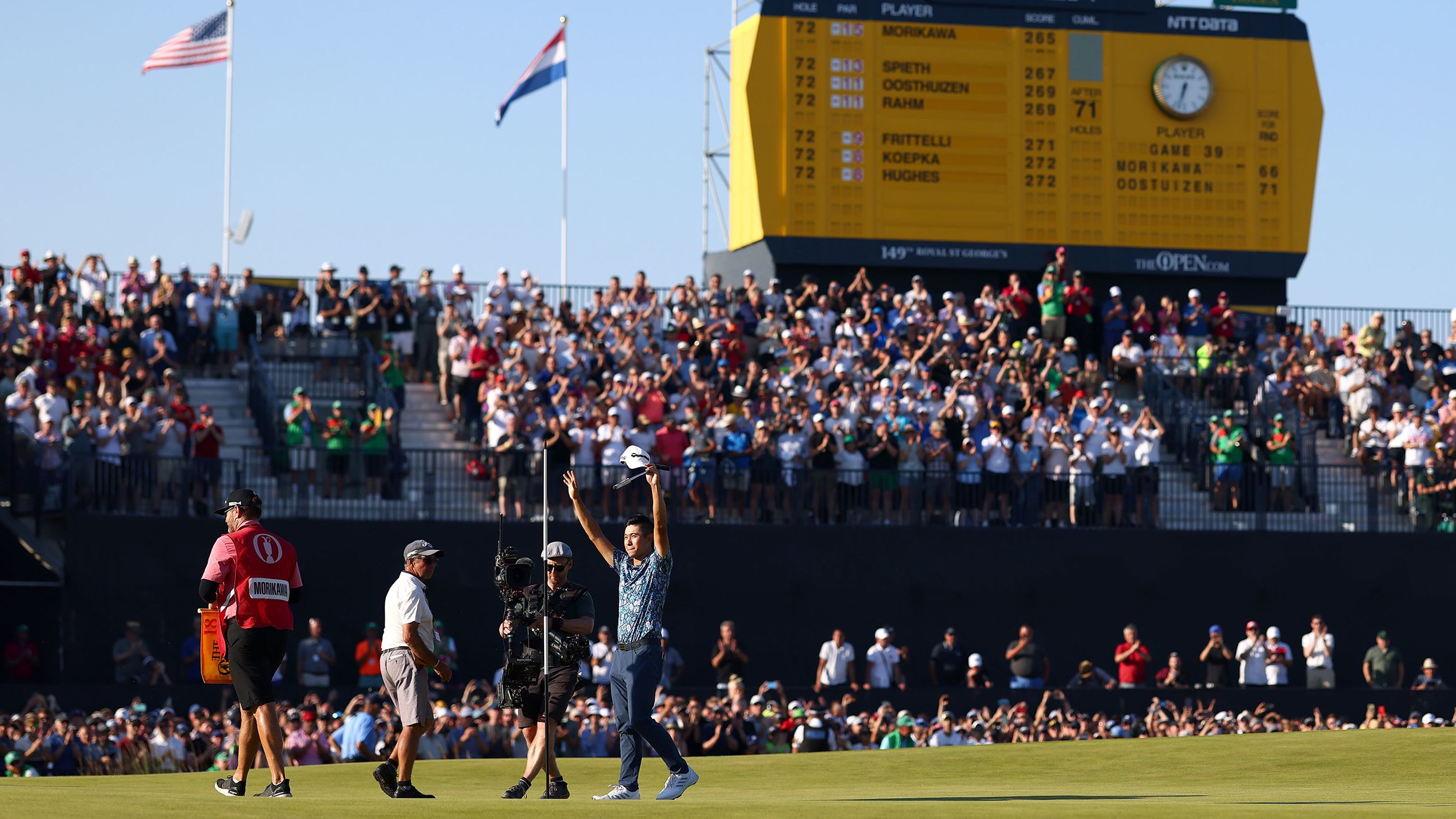 <strong>July 18: </strong>Collin Morikawa stands with his arms aloft after finishing first at The Open at Royal St George's Golf Club. Morikawa became the first man to claim both the PGA Championship and the Open on his debut at the tournaments.