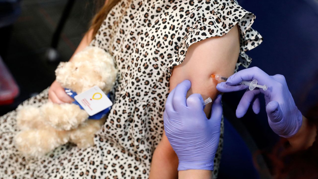 A 6 year-old child receives their first dose of  the Pfizer Covid-19 vaccine at the Beaumont Health offices in Southfield, Michigan, on November 5, 2021.