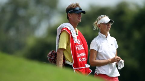 Jessica stands with her caddie and father Petr on the 18th hole during the third round of the HSBC Women's Champions on February 26, 2011.