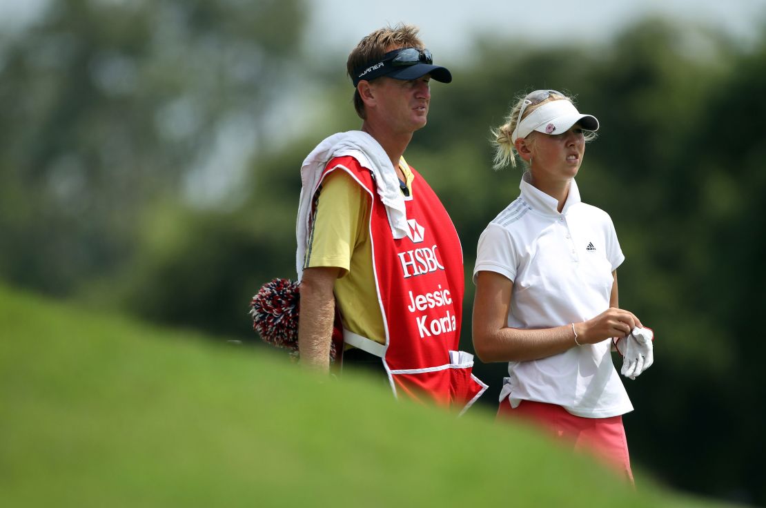 Jessica stands with her caddie and father Petr on the 18th hole during the third round of the HSBC Women's Champions on February 26, 2011.