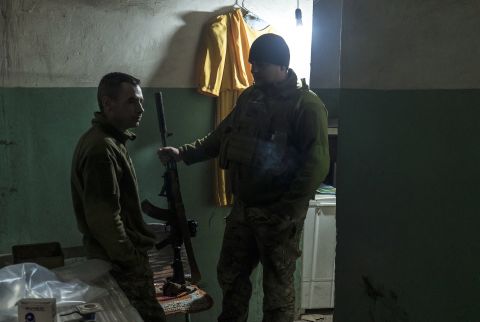 Ukrainian soldiers wait in a building near the front line in Marinka on December 8.