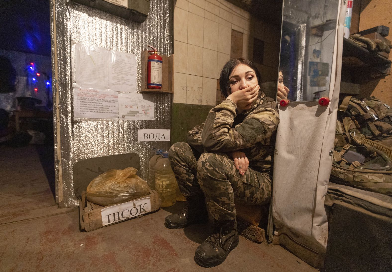 A Ukrainian soldier rests near a fighting position on the line of separation from pro-Russian rebels near Katerinivka, Ukraine, on December 7.