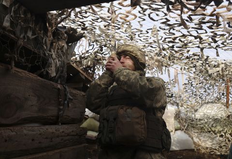 A Ukrainian soldier looks out from a fighting position on the line of separation from pro-Russian rebels near Debaltsevo on December 3.