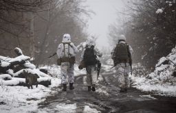 Ukrainian soldiers walks at the line of separation from pro-Russian rebels near Katerinivka, Donetsk region, Ukraine on December 7, 2021. 