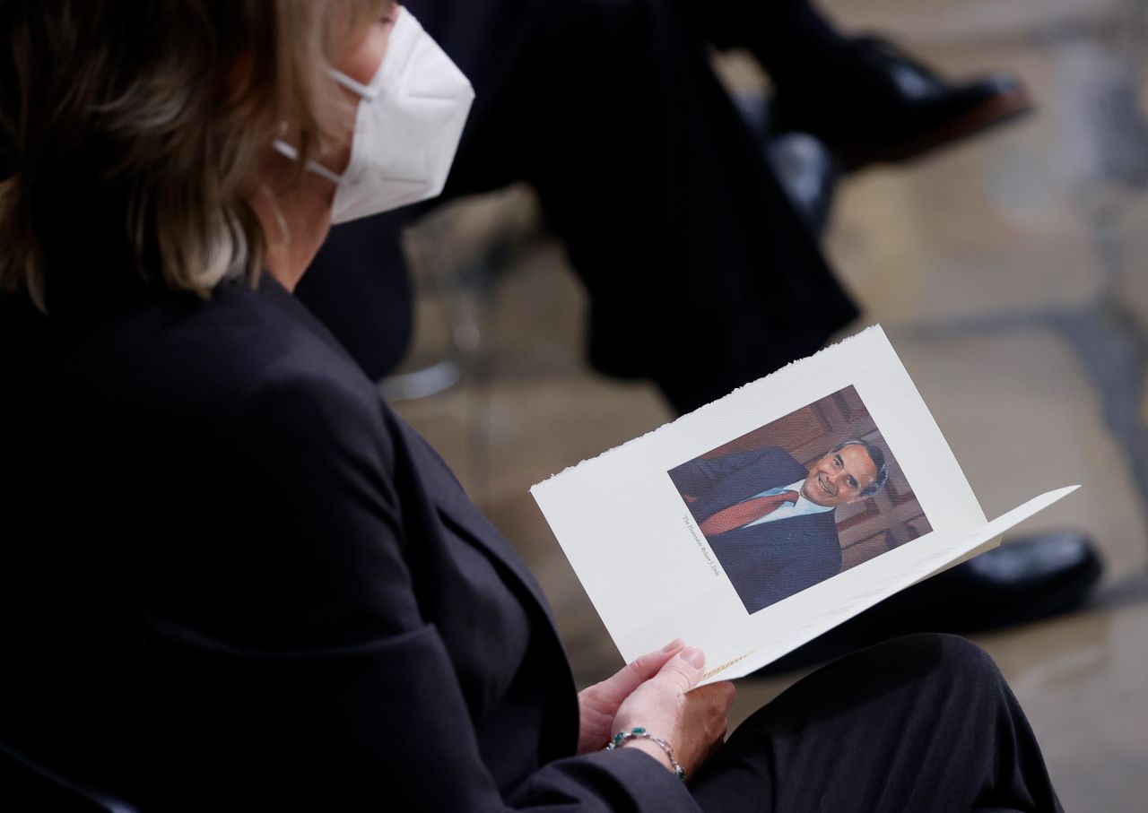 A mourner holds a program prior to a congressional ceremony to honor Dole.