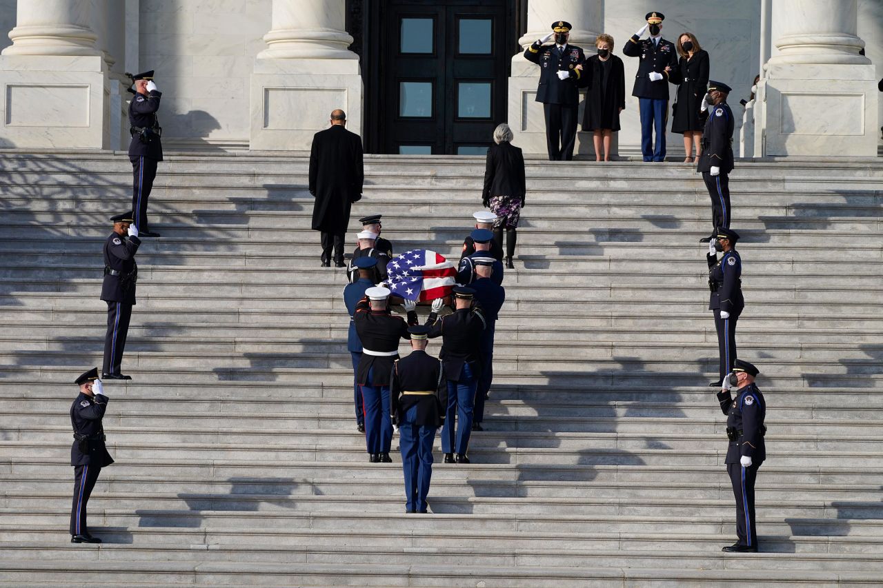 A joint services military bearer team carries Dole's casket.