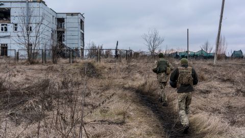 Ukrainian soldiers walk toward a destroyed building in Marinka, Ukraine in December. 