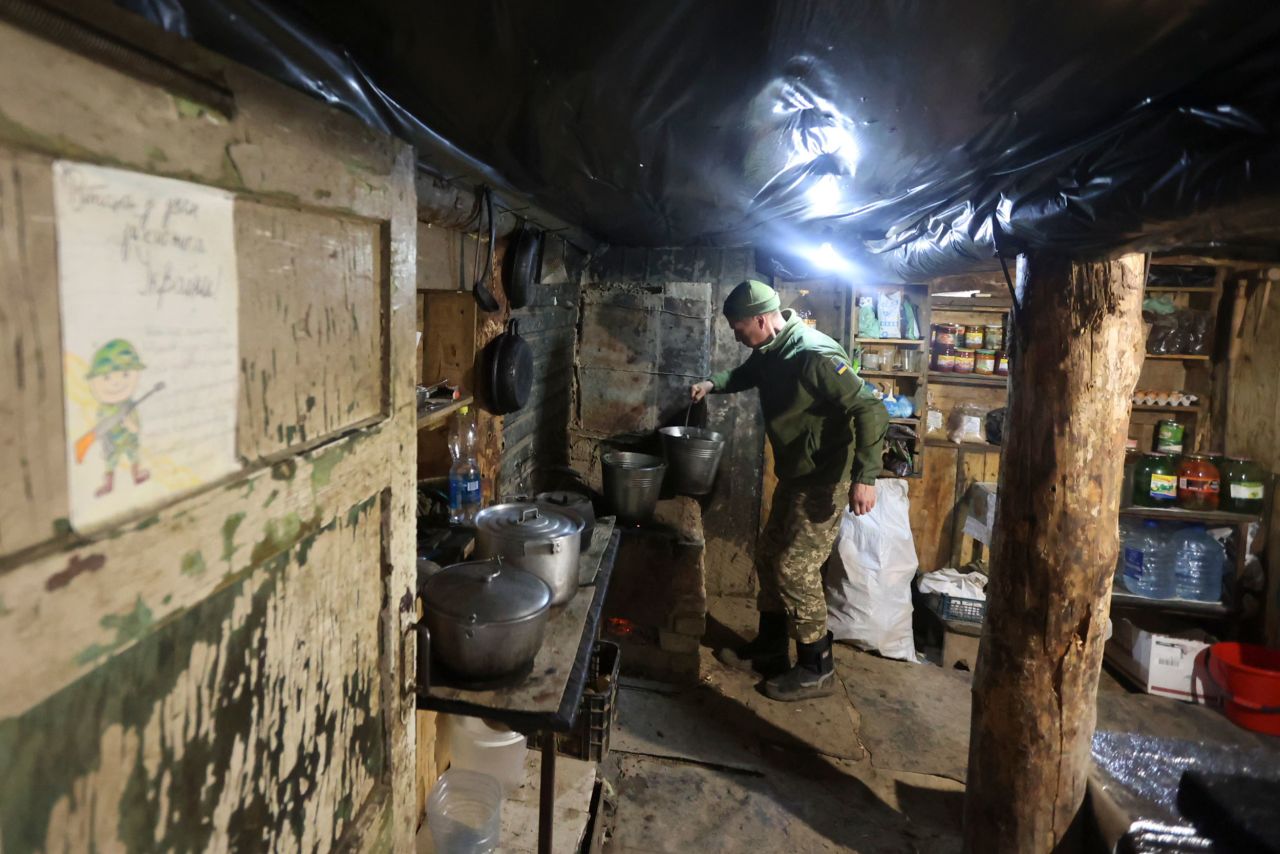 A Ukrainian soldier cooks in a shelter near Debaltsevo, Ukraine, on Friday, December 3.