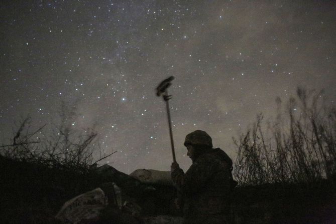 A Ukrainian soldier checks the situation near Svetlodarsk, Ukraine, on December 2.