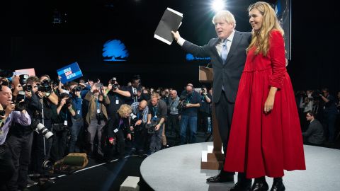 Prime Minister Boris Johnson is joined by his wife Carrie on stage after delivering his keynote speech at the Conservative Party Conference in Manchester, England, on October 6, 2021.