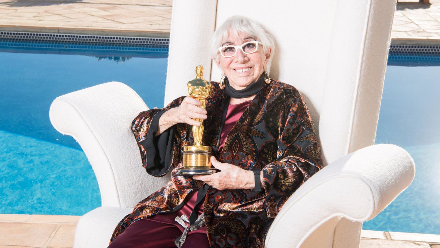 Acclaimed filmmaker Lina Wertmuller, posing in 2019 with her honorary Oscar, has died at age 93, according to Italy's Ministry of Culture.