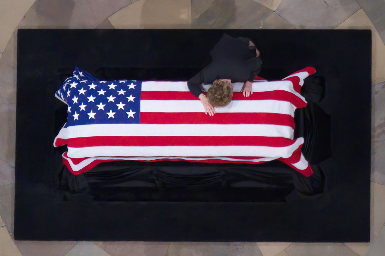 Elizabeth Dole, a former US Senator and the wife of Bob Dole, lays her head on her husband's casket.