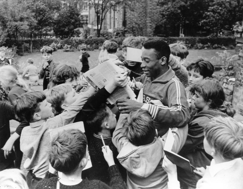 Pelé signs autographs for children in 1966. He played in the 1966 World Cup with Brazil but the team didn't advance out of the group stage that year.