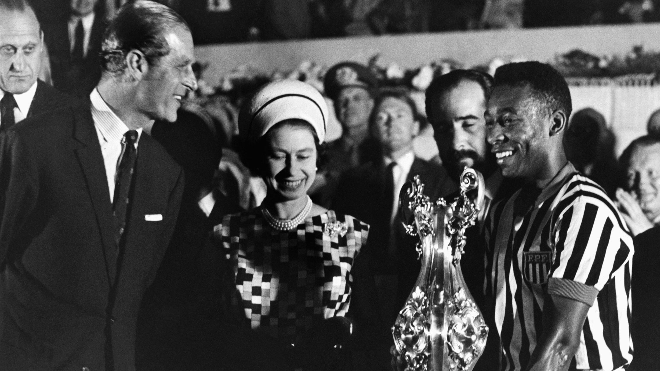 Britain's Queen Elizabeth II, accompanied by her husband, Prince Philip, award a trophy to Pelé after watching a match in Rio de Janeiro in 1968.