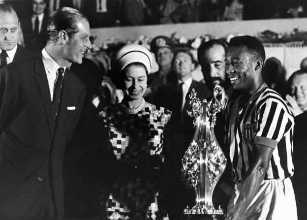 Britain's Queen Elizabeth II, accompanied by her husband, Prince Philip, award a trophy to Pelé after watching a match in Rio de Janeiro in 1968.