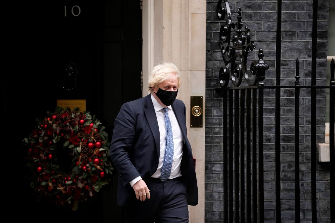 British Prime Minister Boris Johnson leaves 10 Downing Street to attend the weekly Prime Minister's Questions at the Houses of Parliament, in London, Wednesday, Dec. 8, 2021. 
