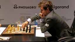 Norway's grandmaster Magnus Carlsen competes with Russia's grandmaster Ian Nepomniachtchi during game 11 in the FIDE World Chess Championship Dubai 2021, at the Dubai Expo 2020 in the Gulf emirate, on December 10, 2021. (Photo by AFP) (Photo by -/AFP via Getty Images)