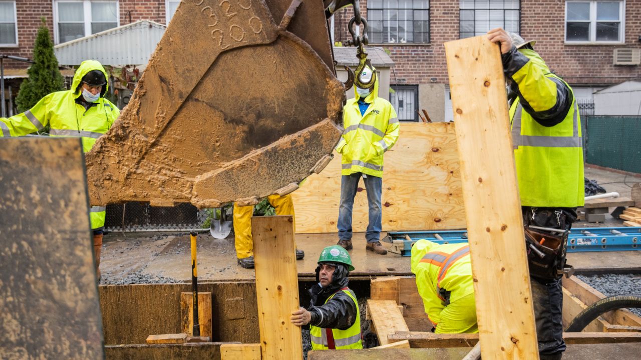 Workers on a construction site repair damage from Hurricane Ida in Queens, New York.