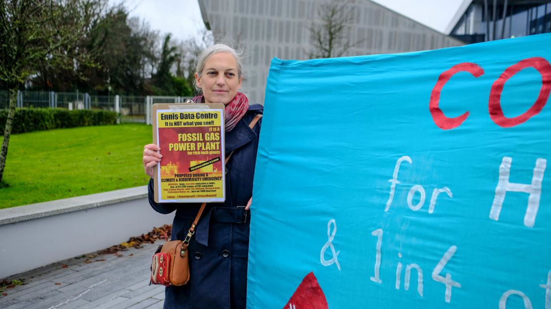 Melina Sharp of Futureproof Clare holds up a sign in protest of the data center outside the Clare County council offices in Ennis. 