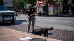 AUSTIN, TX - JUNE 12: An ATF K9 unit surveys the area near the scene of a shooting on June 12, 2021 in Austin, Texas. At least 13 people were taken to hospitals after a shooting happened on Austin's famous 6th Street. The shooter is still at large. (Photo by Sergio Flores/Getty Images)