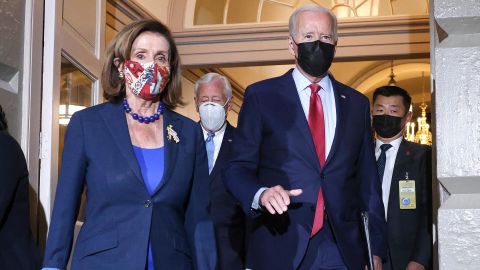 President Joe Biden walks with Pelosi as he arrives to meet with House Democrats at the Capitol in October.