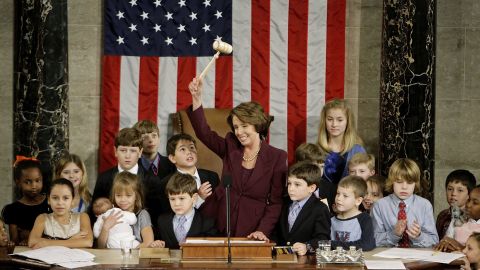 Pelosi waves the speaker's gavel while surrounded by her own grandchildren and the children of other members of Congress after being elected as the first woman speaker at a swearing in ceremony for the 110th Congress in January 2007.